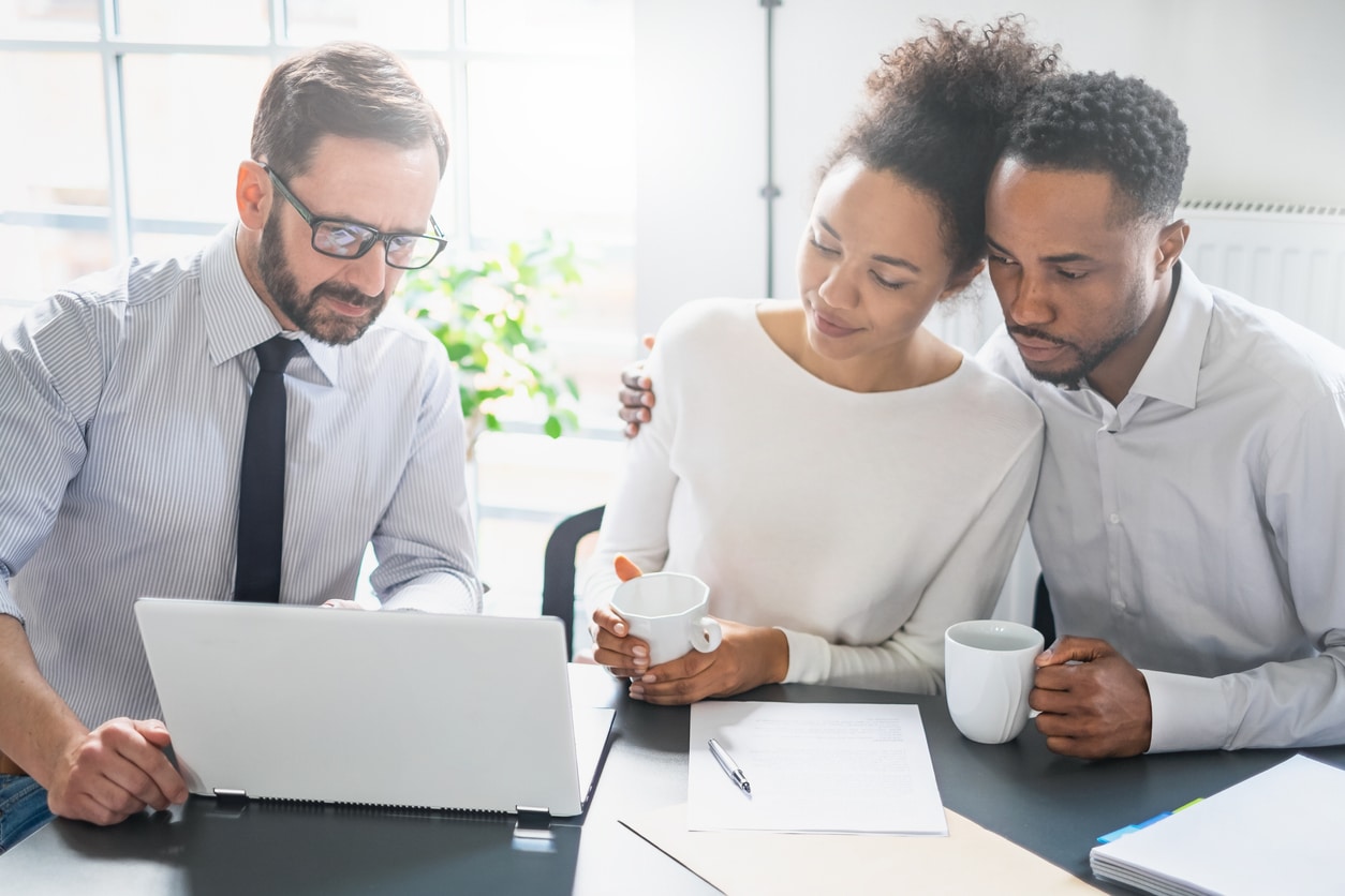 3 people at work discussing what's on the computer in front of them